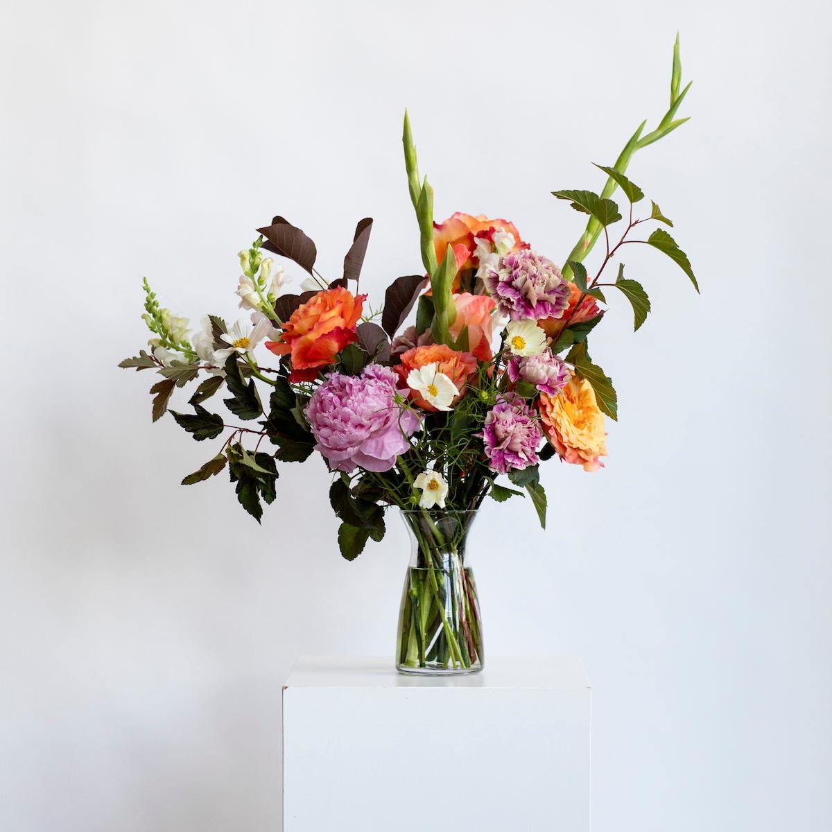 color bundle of flower on a white background in a clear vase