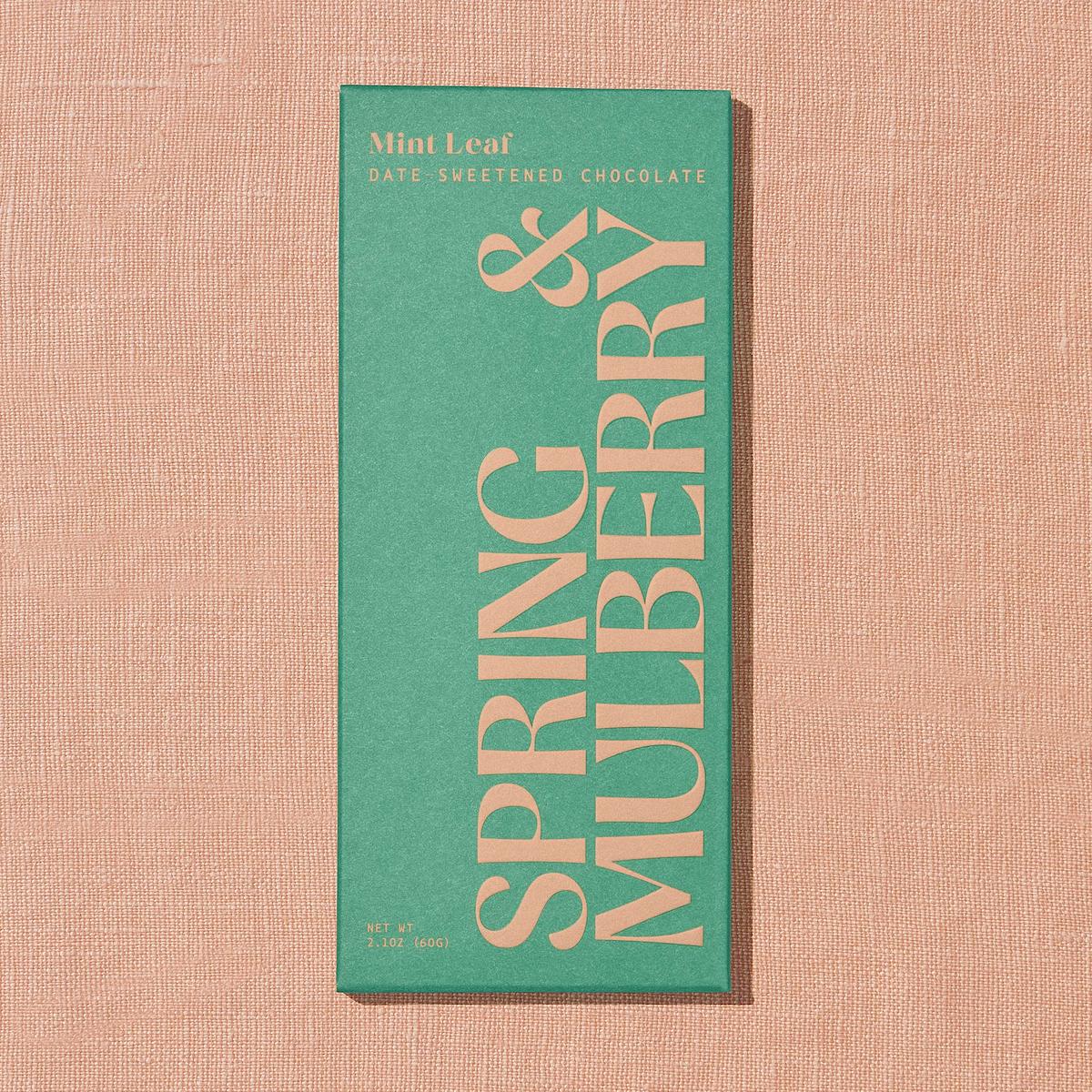 Chocolate bar packaging with 'Spring & Mulberry' text on a textured beige background