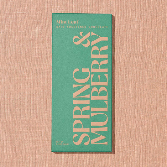 Chocolate bar packaging with 'Spring & Mulberry' text on a textured beige background