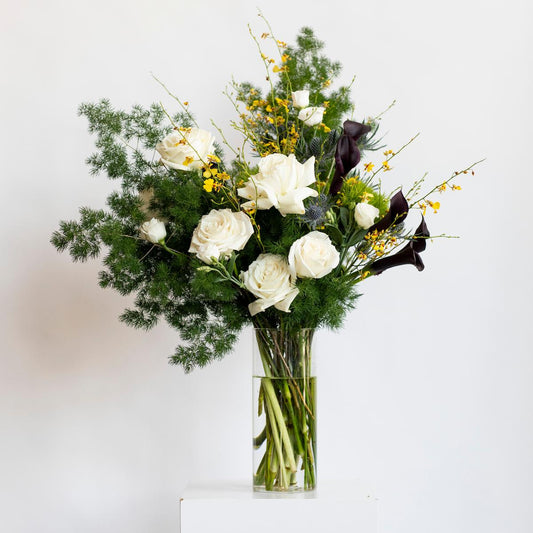 Bouquet of flowers in a clear vase on a white background