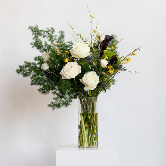 Bouquet of flowers in a clear vase on a white background